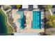 Aerial view of an elaborate community pool with a lazy river, lap pool, and lounge areas at 22473 E Twilight Dr, Queen Creek, AZ 85142