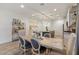 Cozy dining area with a rustic wooden table, stylish chairs, and adjacent bar for entertaining at 22473 E Twilight Dr, Queen Creek, AZ 85142