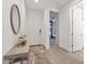 Bright entryway featuring wood-look floors, a decorative mirror, and access to other rooms at 22473 E Twilight Dr, Queen Creek, AZ 85142