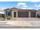Attractive home with a three-car garage and desert landscaping at 22473 E Twilight Dr, Queen Creek, AZ 85142