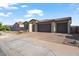Lovely home featuring a three-car garage and low-maintenance landscaping at 22473 E Twilight Dr, Queen Creek, AZ 85142