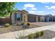 Beautiful home with a three-car garage, desert landscaping, and a charming facade at 22473 E Twilight Dr, Queen Creek, AZ 85142