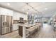 Bright, open kitchen featuring stainless steel appliances, granite countertops, and a large island with seating at 22473 E Twilight Dr, Queen Creek, AZ 85142