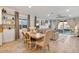 Inviting living room with dining area, featuring stylish furnishings and access to outdoor patio at 22473 E Twilight Dr, Queen Creek, AZ 85142