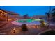 Outdoor pool boasts a waterfall feature and landscape lighting for nighttime enjoyment in this oasis at 24721 W Dove Butte --, Buckeye, AZ 85326