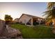 Wide backyard featuring a well-maintained lawn and covered patio, perfect for relaxation and outdoor entertaining at 24721 W Dove Butte --, Buckeye, AZ 85326
