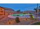 Outdoor pool boasts a waterfall feature and landscape lighting for nighttime enjoyment in this beautiful backyard at 24721 W Dove Butte --, Buckeye, AZ 85326