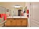 Bright bathroom showcasing double sinks, wooden cabinets, and a large mirror reflecting the adjacent space at 24721 W Dove Butte --, Buckeye, AZ 85326