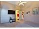 Well-lit bedroom featuring ceiling fan, TV, and neutral color palette at 24721 W Dove Butte --, Buckeye, AZ 85326