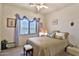 Charming bedroom offers a cozy atmosphere with a window dressed with delicate fabric and comfortable bedding at 24721 W Dove Butte --, Buckeye, AZ 85326