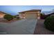 Home exterior with stone accents, desert landscaping, concrete driveway, and a two car garage at 24721 W Dove Butte --, Buckeye, AZ 85326