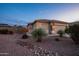 Well-maintained front yard with desert landscaping, gravel, and a charming walkway to the house at 24721 W Dove Butte --, Buckeye, AZ 85326