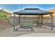 Backyard gazebo featuring a hot tub, bar seating, and a cozy atmosphere for outdoor relaxation and entertaining at 24721 W Dove Butte --, Buckeye, AZ 85326