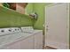 Functional laundry room features a washer and dryer with a storage shelf above at 24721 W Dove Butte --, Buckeye, AZ 85326