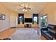 Living room with wood floors, ceiling fan, recessed lights, and leather furniture at 24721 W Dove Butte --, Buckeye, AZ 85326