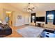 Living room with wood floors, ceiling fan, recessed lights, and leather furniture at 24721 W Dove Butte --, Buckeye, AZ 85326
