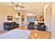Living room with wood floors, ceiling fan, recessed lights, and leather furniture at 24721 W Dove Butte --, Buckeye, AZ 85326