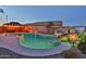 A resort-style pool with waterfall feature, colorful lights, desert landscaping, and a gazebo with hot tub at 24721 W Dove Butte --, Buckeye, AZ 85326