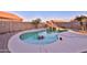 Private pool with a rock waterfall feature, surrounded by a block fence and some privacy landscaping at 24721 W Dove Butte --, Buckeye, AZ 85326