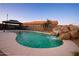 Beautiful pool features a rock waterfall feature and desert landscaping for a serene backyard at 24721 W Dove Butte --, Buckeye, AZ 85326