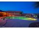 A resort-style pool with waterfall feature, colorful lights, desert landscaping, and a gazebo with hot tub at 24721 W Dove Butte --, Buckeye, AZ 85326