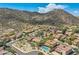 Scenic aerial view of desert homes nestled against a mountain backdrop, featuring tile roofs and private pools at 25929 N 84Th Ln, Peoria, AZ 85383