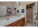 Bathroom with a double sink vanity, a large mirror, and a separate toilet and shower room at 25929 N 84Th Ln, Peoria, AZ 85383