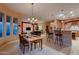 Dining area with table, chairs, chandelier, and view of living room and kitchen at 25929 N 84Th Ln, Peoria, AZ 85383