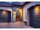 Stucco home with a view of a cozy fireplace through the entryway and a beautiful brick-paved driveway at 25929 N 84Th Ln, Peoria, AZ 85383