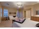Bright main bedroom boasts a cozy seating area, soft carpet, and a neutral color palette at 25929 N 84Th Ln, Peoria, AZ 85383