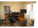 Well-lit office features a large desk with dual monitors and a comfortable ergonomic chair at 25929 N 84Th Ln, Peoria, AZ 85383