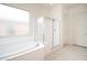 Bright bathroom featuring soaking tub and glass shower enclosure at 26190 W Siesta Ln, Buckeye, AZ 85396