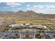 An aerial shot of the community showcasing its pool, clubhouse and golf course with scenic mountain views at 26190 W Siesta Ln, Buckeye, AZ 85396