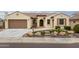 Charming, earth-toned home featuring a tile roof, arched entryway, and desert-friendly landscaping at 26190 W Siesta Ln, Buckeye, AZ 85396