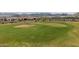 Beautifully manicured golf course green with a sand trap, offering a challenging yet scenic experience at 26190 W Siesta Ln, Buckeye, AZ 85396