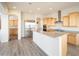 Bright kitchen features stainless steel appliances, granite countertops and light wood cabinets at 26190 W Siesta Ln, Buckeye, AZ 85396