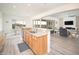 Kitchen with granite countertops, stainless steel sink and open to the dining and living room at 26190 W Siesta Ln, Buckeye, AZ 85396