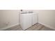 Laundry area features a washer and dryer with a neutral paint and wood-look floors at 26190 W Siesta Ln, Buckeye, AZ 85396