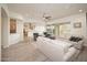 Bright living room with plank floors, neutral furniture and an open floor plan to the kitchen at 26190 W Siesta Ln, Buckeye, AZ 85396