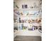 Walk-in pantry with lots of shelving and storage for food and household items at 26190 W Siesta Ln, Buckeye, AZ 85396