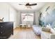 bedroom featuring a whimsical themed wall, a ceiling fan, and bright natural light at 2710 E Cinnabar Ave, Phoenix, AZ 85028