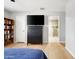 Bedroom featuring wood floors, a ceiling fan, and ensuite bathroom access at 2710 E Cinnabar Ave, Phoenix, AZ 85028