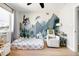 bedroom featuring a whimsical themed wall, bright lighting, and comfortable chair at 2710 E Cinnabar Ave, Phoenix, AZ 85028