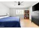 Cozy bedroom with a ceiling fan, wood floors, and a built-in bookshelf at 2710 E Cinnabar Ave, Phoenix, AZ 85028