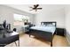 Bedroom featuring wood floors, bright natural light, and an office setup at 2710 E Cinnabar Ave, Phoenix, AZ 85028