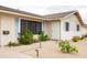 Close-up of the home's front entrance featuring a security door, desert landscaping, and charming light-blue shutters at 2710 E Cinnabar Ave, Phoenix, AZ 85028