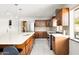 Open kitchen with dark-wood cabinets, tile backsplash, and modern fixtures at 2710 E Cinnabar Ave, Phoenix, AZ 85028