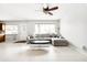 Comfortable living room featuring light tile flooring, a modern ceiling fan, and a cozy sectional sofa at 2710 E Cinnabar Ave, Phoenix, AZ 85028