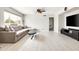 Bright living room showcasing an oversized couch, and modern tile flooring that exudes a refreshing ambiance at 2710 E Cinnabar Ave, Phoenix, AZ 85028