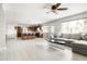 Open-concept living area with kitchen island, spacious couch and modern tile floors at 2710 E Cinnabar Ave, Phoenix, AZ 85028